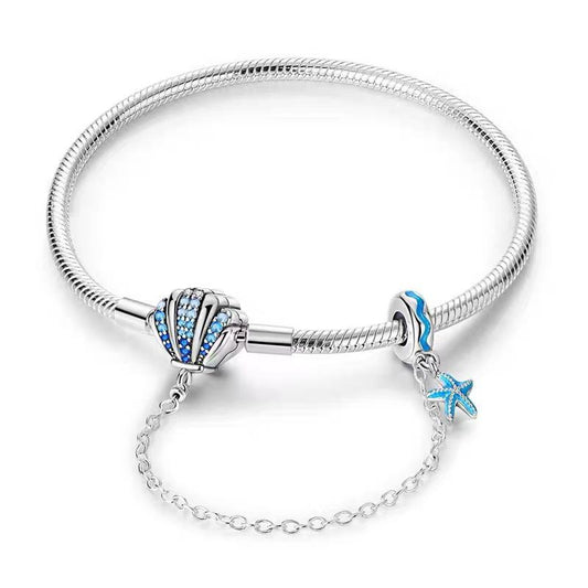 Ocean Shell Pavé Blue CZ Clasp Charm Bracelet — 925 sterling silver snake chain with blue CZ pavé shell clasp, teal enamel wave bead and starfish dangle, silver safety chain